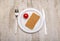 Plate with cutlery, tomato and slice of bread