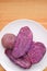 Plate of Delectable Steamed Unpeeled Purple Sweet Potatoes Showing Vivid Color Flesh