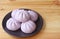 Plate of Delectable Taro Stuffed Steamed Buns on Wooden Background