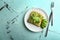 Plate with delicious avocado toast on table, top view