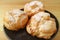 Plate of Delicious French Cream Puffs Sprinkled with Icing Sugar