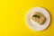 Plate with delicious Napoleon cake on yellow background