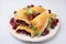 Plate of delicious samosas, berries and mint leaves on white tiled table
