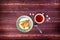 Plate with delicious samosas or samsa with tea on wooden background. Top view