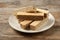 Plate of delicious wafers on brown wooden