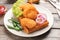 Plate with delicious waffle and chicken nuggets on wooden table