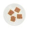 Plate of deviled ham on crackers atop a white background.