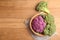 Plate with different cabbages on wooden table, top view