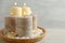 Plate with different candles and rocks on table