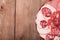 Plate with different sliced sausage on an old wooden table. With