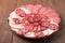 Plate with different sliced sausage on an old wooden table. Tint