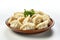 A plate of dumplings with a sprig of parsley.