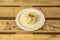 Plate of ensaladilla rusa typical to serve in a tapas bar on a surface of unvarnished wooden planks