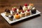 A plate filled with an assortment of cute mini desserts