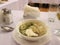 A plate filled with food with dumplings with sour cream in broth is a Russian hot dish in a restaurant