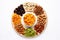 Plate filled with variety of nuts including almonds, dried apricots, raisins, and more. Perfect for snacking or as healt