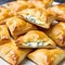 Plate of flaky puff pastries filled with soft and creamy cheeses