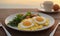 A plate of food featuring a fried egg on top, showcasing a hearty and satisfying meal.