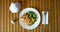 Plate with food next to a mask in a restaurant.