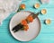 Plate, fork, knife, candle, rose flower on wooden background