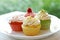 Plate of four colorful springtime cupcakes