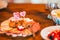 Plate of a fresh assortment of meat on the wooden dinner table