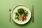 Plate of fresh and colorful broccoli and tomatoes, artfully presented with fork on vibrant green background. Healthy eating and