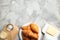 Plate of fresh croissants served on grey table, flat lay. French pastry