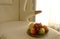 Plate with fresh fruits on beige color single sofa chair in living room.Close up