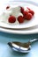 A plate of fresh raspberries served with yogurt