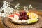 Plate with fresh sliced fruits. Banana, grapes. grapefruit, orange