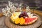 Plate with fresh sliced fruits. Banana, grapes. grapefruit, orange