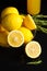 Plate of fresh sliced lemons, rosemary, bottle with lemon drink