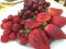 Plate of fresh strawberries, grapes and raspberries