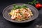 plate of freshly cooked pasta with shrimps and herbs