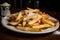 a plate of freshly made chips, with a sprinkle of salt and pepper