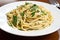 plate of freshly made linguine, tossed with fresh herbs and garlic