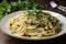 plate of freshly made linguine, tossed with fresh herbs and garlic