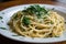 plate of freshly made linguine, tossed with fresh herbs and garlic