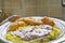 A plate of fried, breaded cassava, rice and groundnut sauce