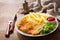 Plate of fried breaded chicken meat or Schnitzel with french fries and salad