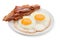 Plate with fried eggs, bacon isolated on white background