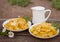 Plate of fried potatoes with sour cream and cheese with milk - country lunch