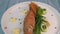 Plate of fried small fish red mullet with green asparagus