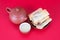 A plate of fried spring rolls and teapots and bowls on a red background