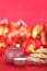 A plate of fried spring rolls and teapots and bowls on a red festive background