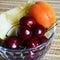 A plate of fruit. good nutrition. apricot, cherry, melon in a glass plate. breakfast.