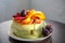 Plate with fruits, melon, peaches and figs on the table