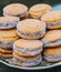 Plate full of cornstarch alfajores filled with dulce de leche. Typical South American dessert.