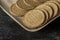 A plate full of English marie biscuits with dark background. Selective focus